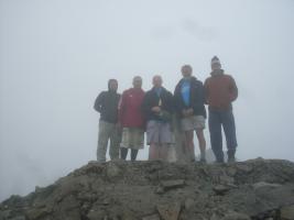 l-r Jim Gardner, Ed Campbell, birthday boy Tony Ford with bottle of champagne, Graham Russell and Gordon Robb at the summit of Ben Nevis.